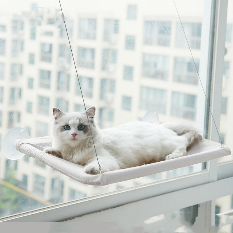 Light gray window cat hammock with white cat lounging