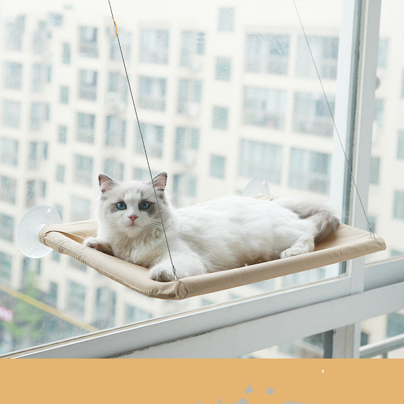 Beige window cat hammock with white cat lounging