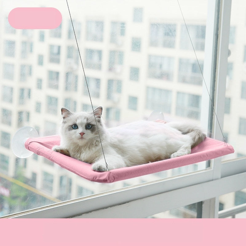 Pink window cat hammock with white cat lounging
